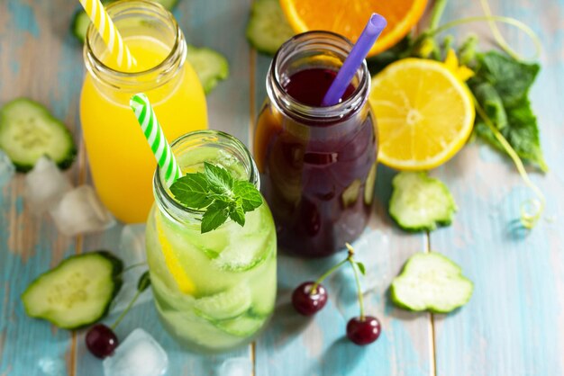 Various refreshments drinks Cherry juice detox cucumber water and orange juice