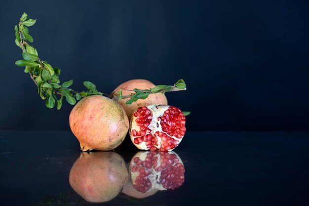 Various ripe pomegranate fruits with pomegranate leaves