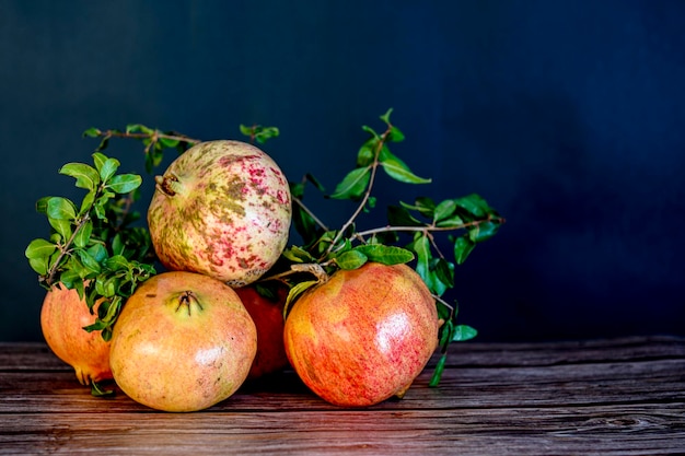 Various ripe pomegranate fruits with pomegranate leaves