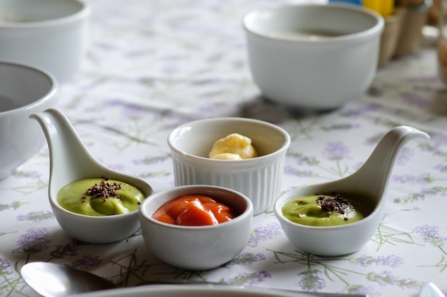 various savory sauce in spoon on table