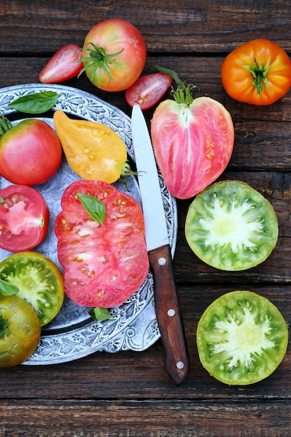Various shapes and colors of tomatoes in metal plate