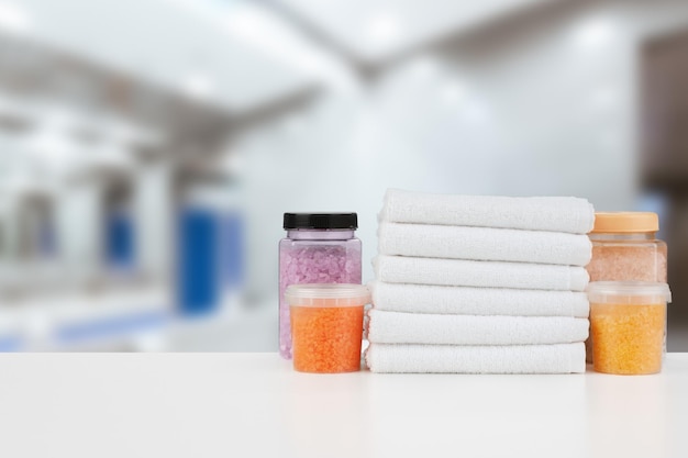 Various spa beauty threatment products and towels against blurred background