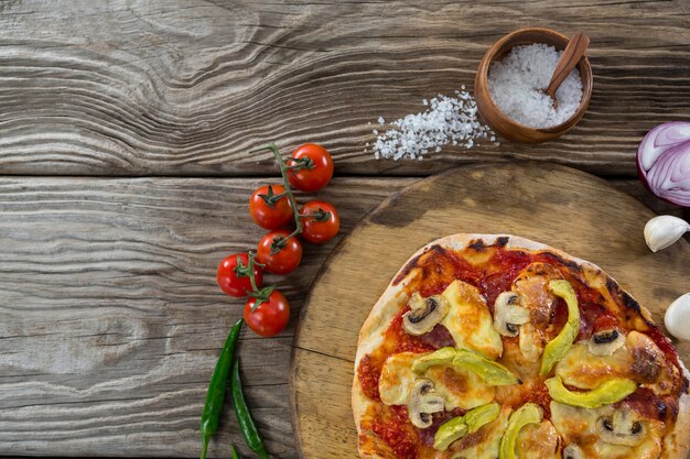 Various species with pizza arranged on wooden tray