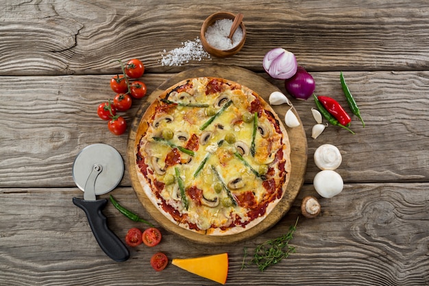 Various species with pizza and tomato on a wooden tray