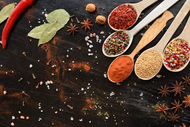 Various spices against a dark background. Food ingredients. It can be used as a background