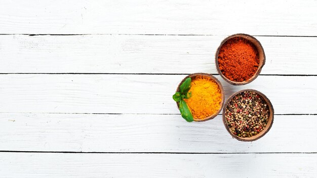 Photo various spices in a bowls on white background indian spices top view