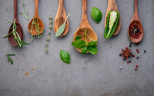 Various of spices and herbs in wooden spoons. 