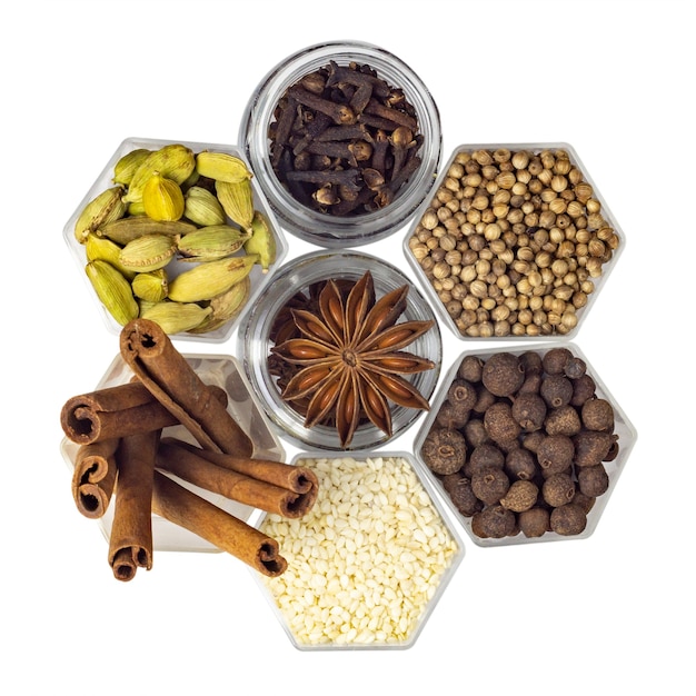 Various spices in hexagonal jars isolated