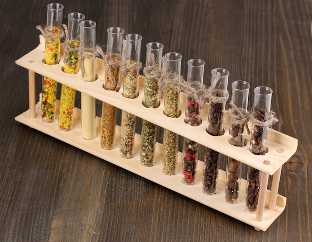 Photo various spices in tubes on wooden background
