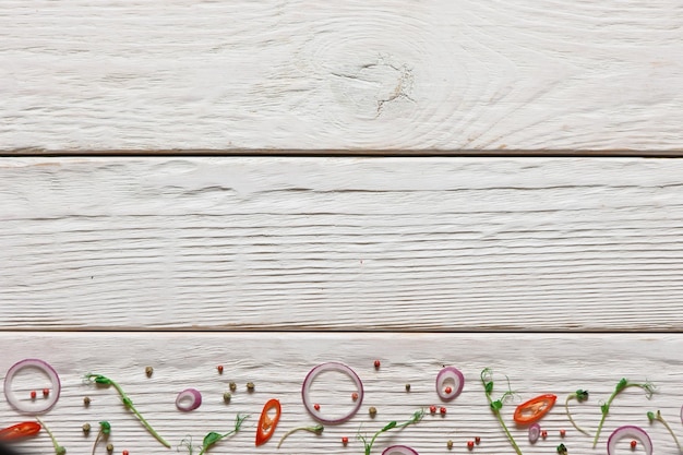 Various spices on white wood background