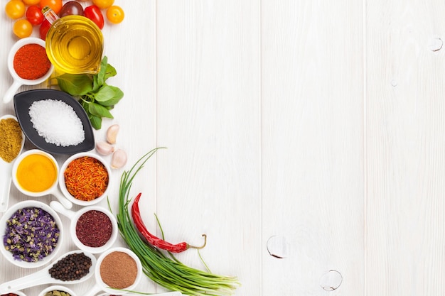 Various spices on white wooden background