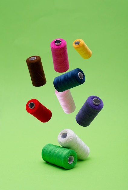 Photo various spools of sewing cotton thread of different colors floating