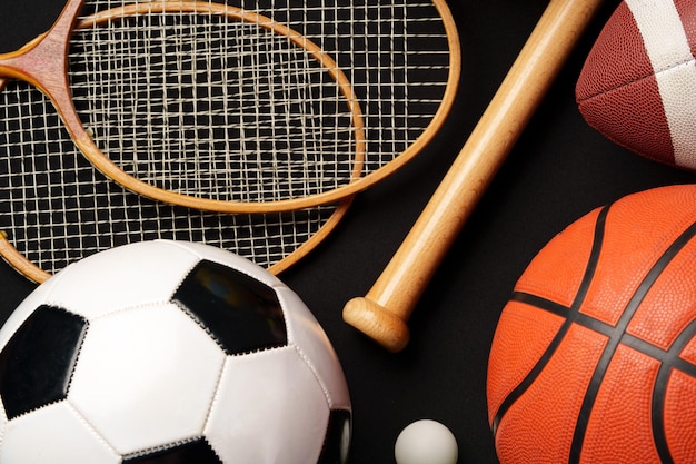 Photo various sports equipment on black background studio shot