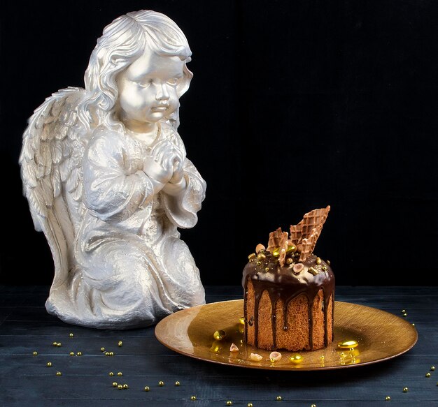 Various Spring Easter cakes with white icing and sugar decor on the table decorated in rustic style