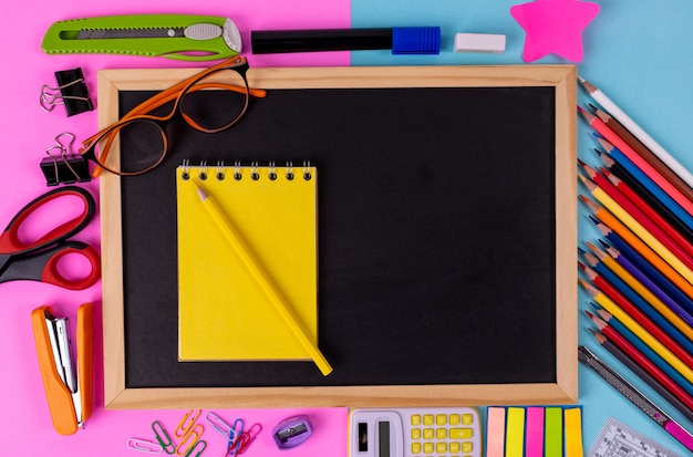 Various stationary are placed on  pink and blue sky