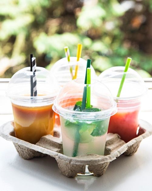 Various summer cold drinks and cocktails in a paper holder