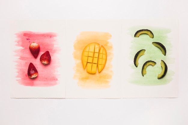 Various tasty fruits on multicolored watercolor splash