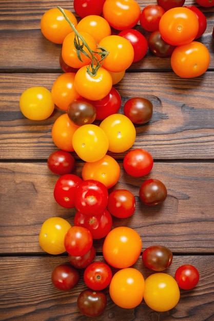 Various tomatoes on dark wooden table