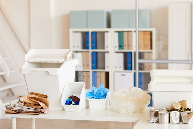 various trash items sorted by material type and ready for recycling in office interior