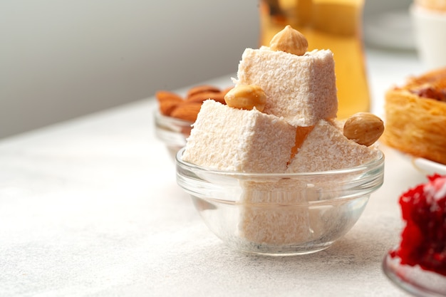 Various turkish sweets on white textured background