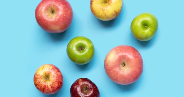 Various types of apples on blue background