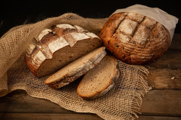 Various types of bread on wooden background