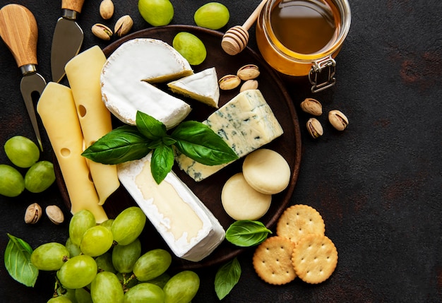 Various types of cheese on a black concrete desk