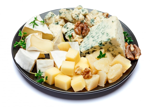 Various types of cheese in dark plate