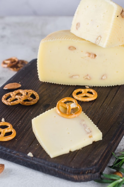 Various types of cheese heads and pieces on a wooden board