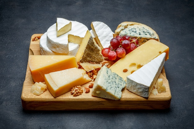 Various types of cheese - parmesan, brie, roquefort, cheddar