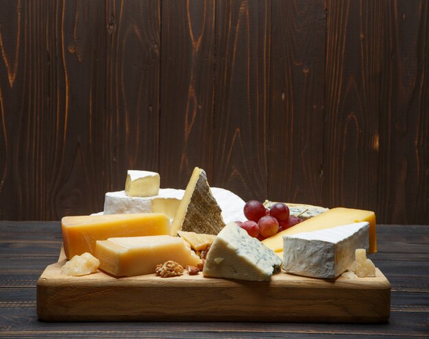 Various types of cheese - parmesan, brie, roquefort, cheddar