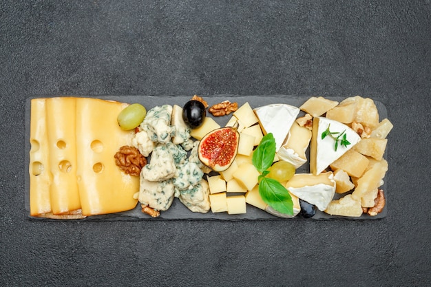 Various types of cheese on stone board