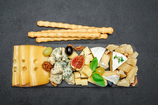 Various types of cheese on stone board