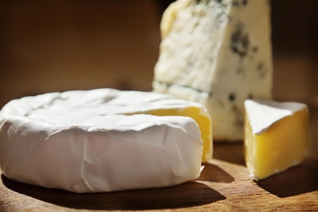 Various types of cheese on a table, soft focus