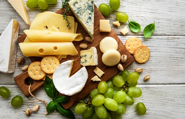 Various types of cheese  on a white wooden  surface