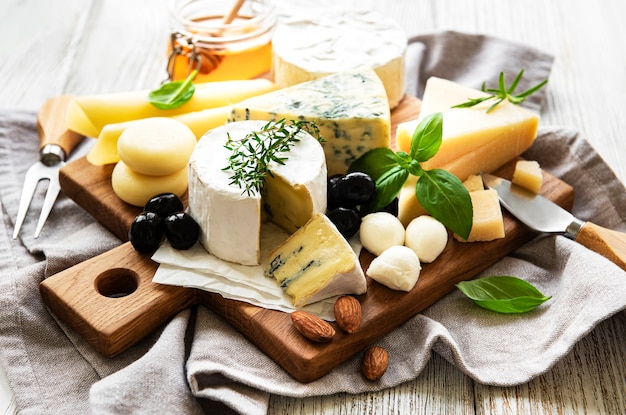 Various types of cheese  on a white wooden  surface