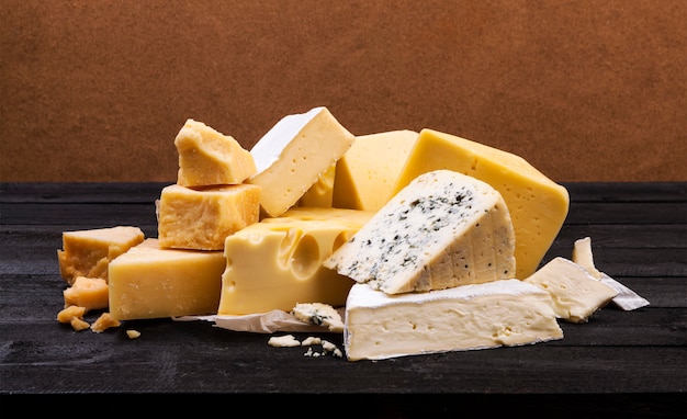 Various types of cheese on wooden surface table