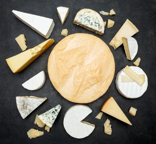 Various types of cheese on a wooden table