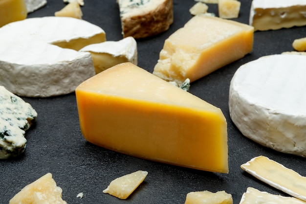 Various types of cheese on a wooden table