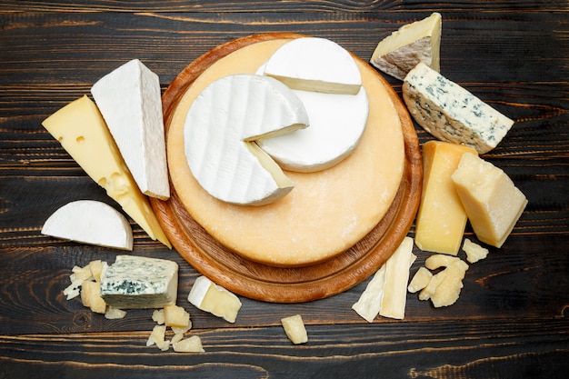 Various types of cheese on a wooden table