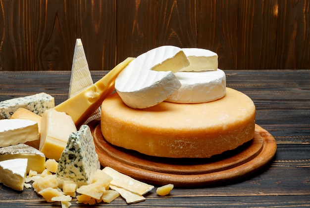 Various types of cheese on a wooden table