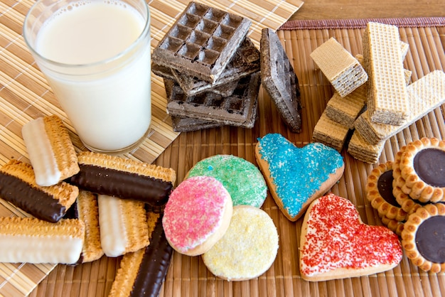 Various types of cookies and biscuits, stuffed and homemade with glass of milk.