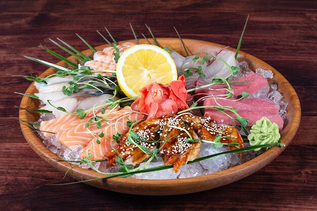 Various types of fish on a plate with ice and lemon