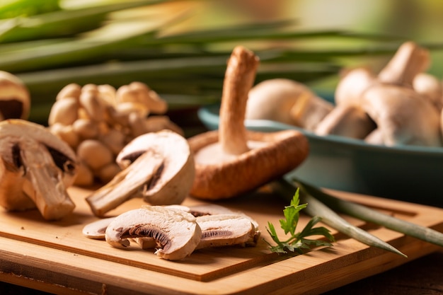 Various types of mushrooms on a wooden table.