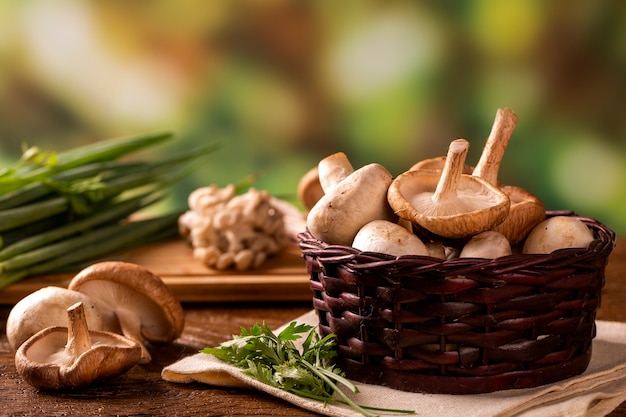 Various types of mushrooms on a wooden table.