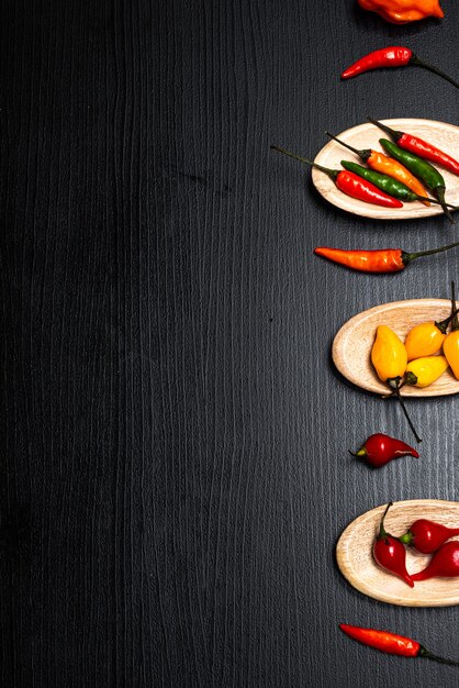 Various types of red chilli pepper and red pepper from Brazil in wooden spoons