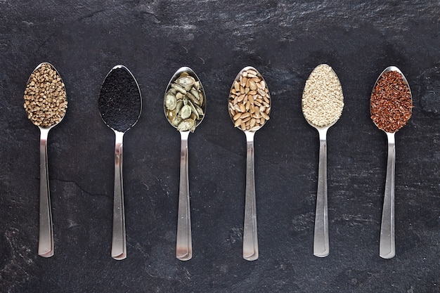 Various types of seeds in spoons