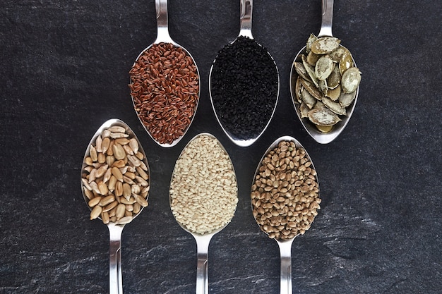 Various types of seeds in spoons