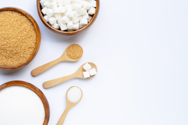 Various types of sugar on white background.