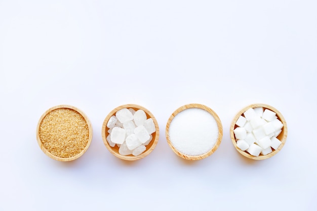 Various types of sugar on white background.